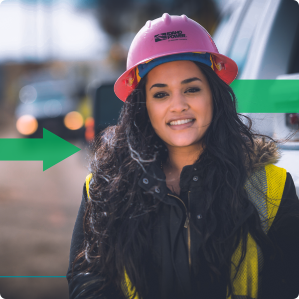 Smiling woman wearing a pink safety helmet.