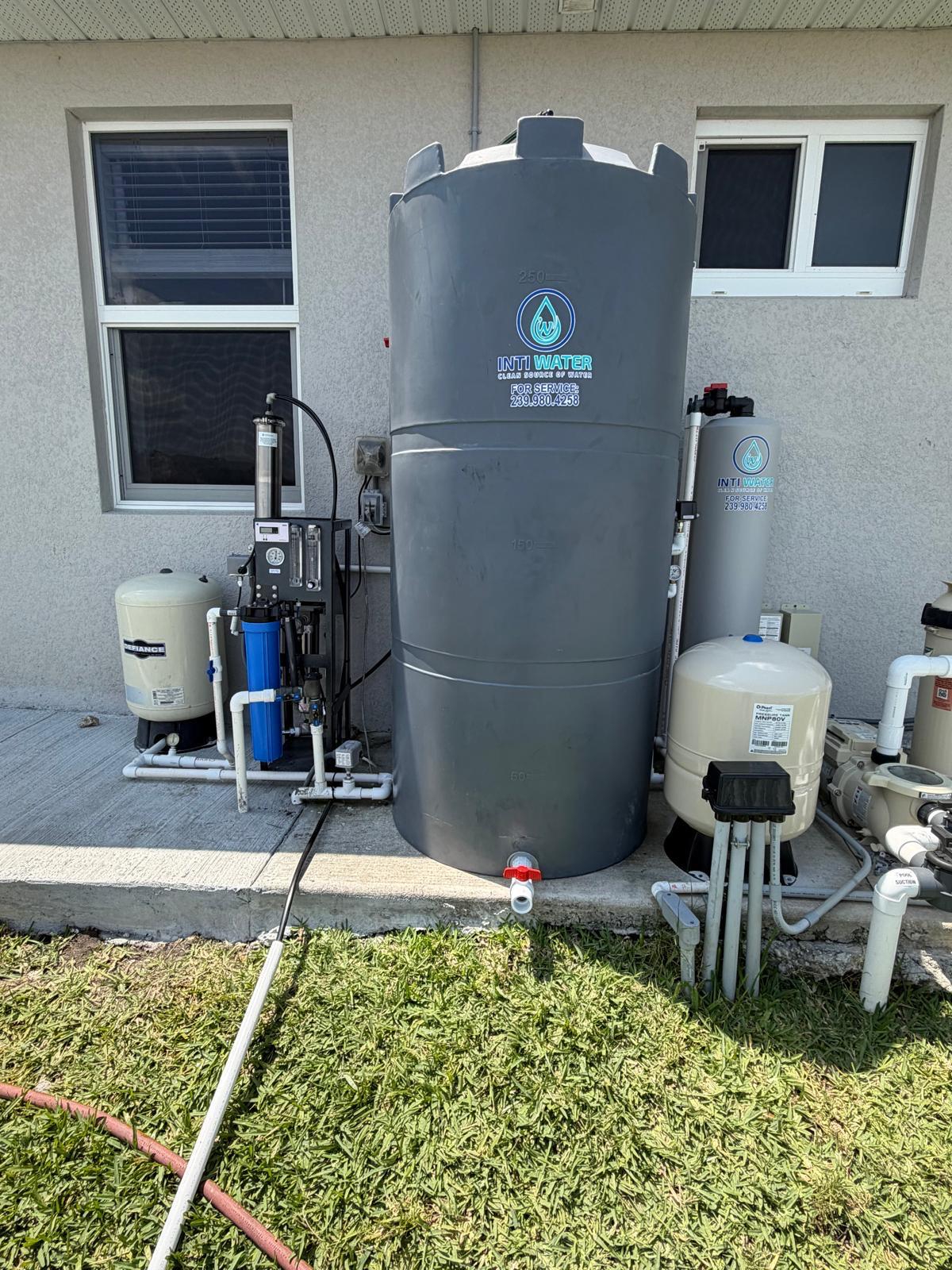 Inti Water whole-home reverse osmosis system installed on a concrete pad in Southwest Florida — storage tank, dual-membrane RO unit, pressure tanks and control panel.