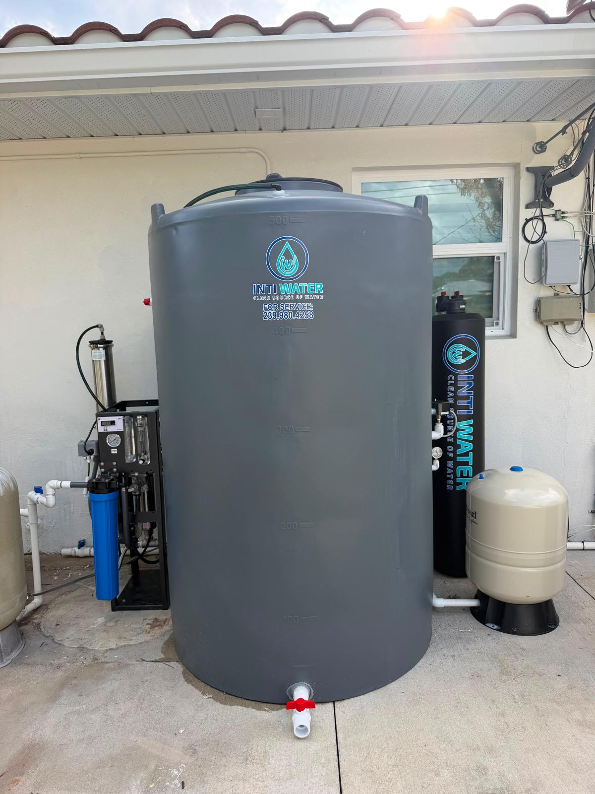 Inti Water whole-home reverse osmosis system installed on a concrete pad in Southwest Florida — storage tank, dual-membrane RO unit, pressure tanks and control panel.