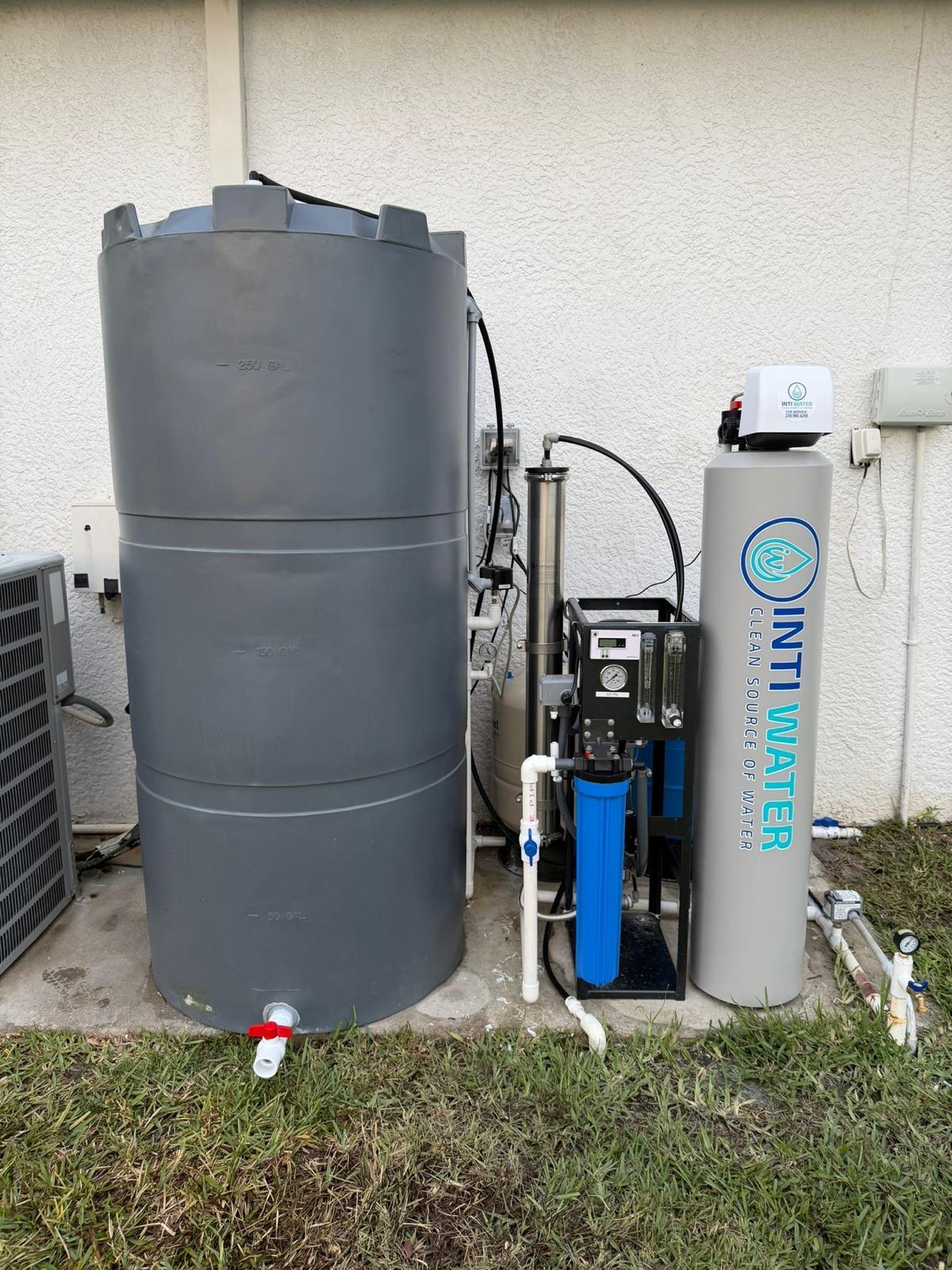 Inti Water whole-home reverse osmosis system installed on a concrete pad in Southwest Florida — storage tank, dual-membrane RO unit, pressure tanks and control panel.