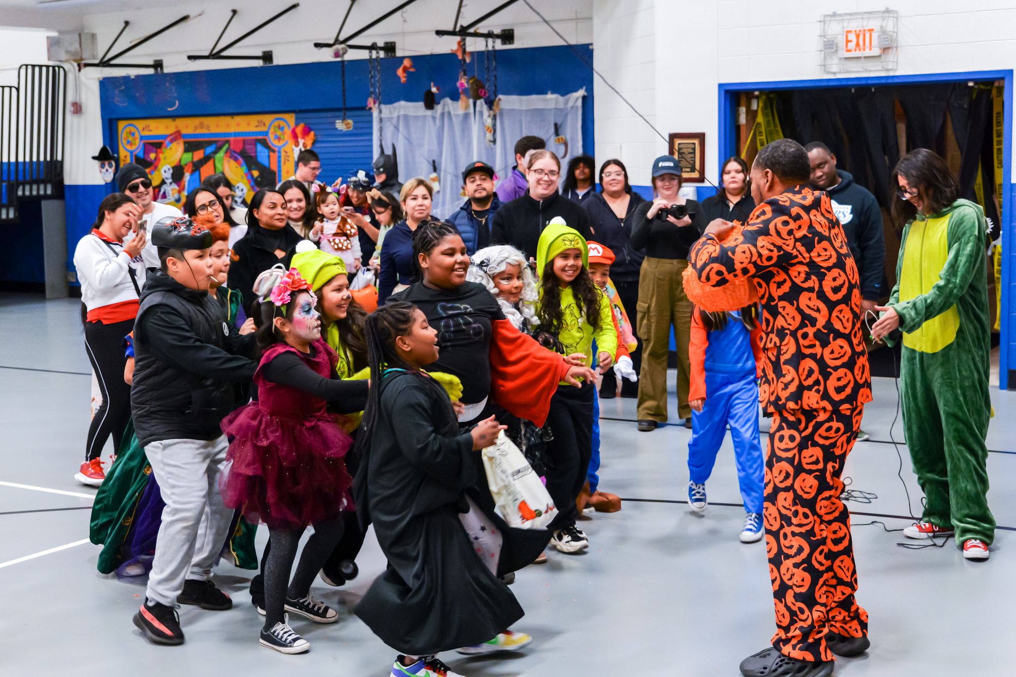 Children participating in a pinata at the Kozy Community Center Halloween Resource Fair event