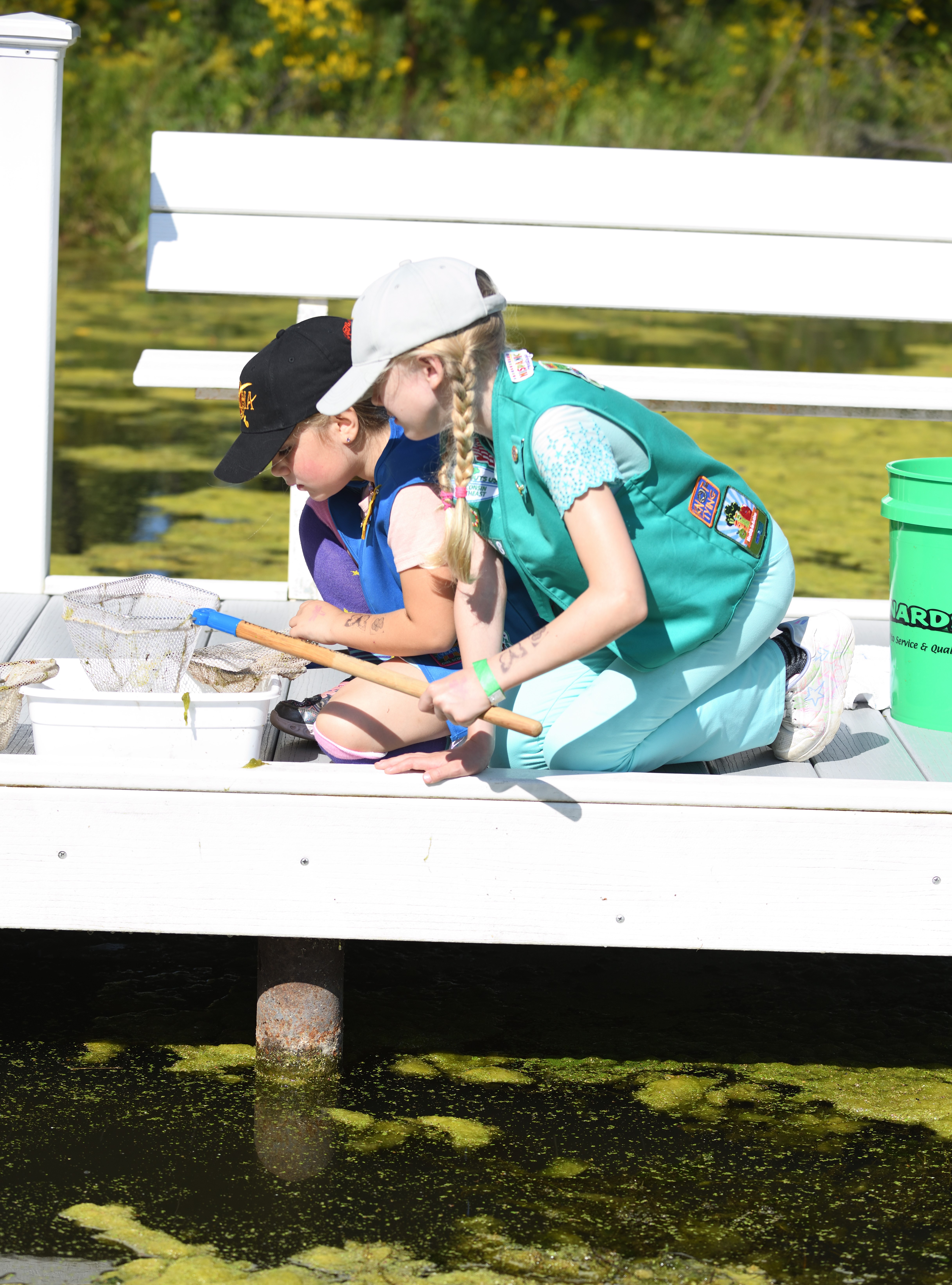 Kids looking at bugs near water