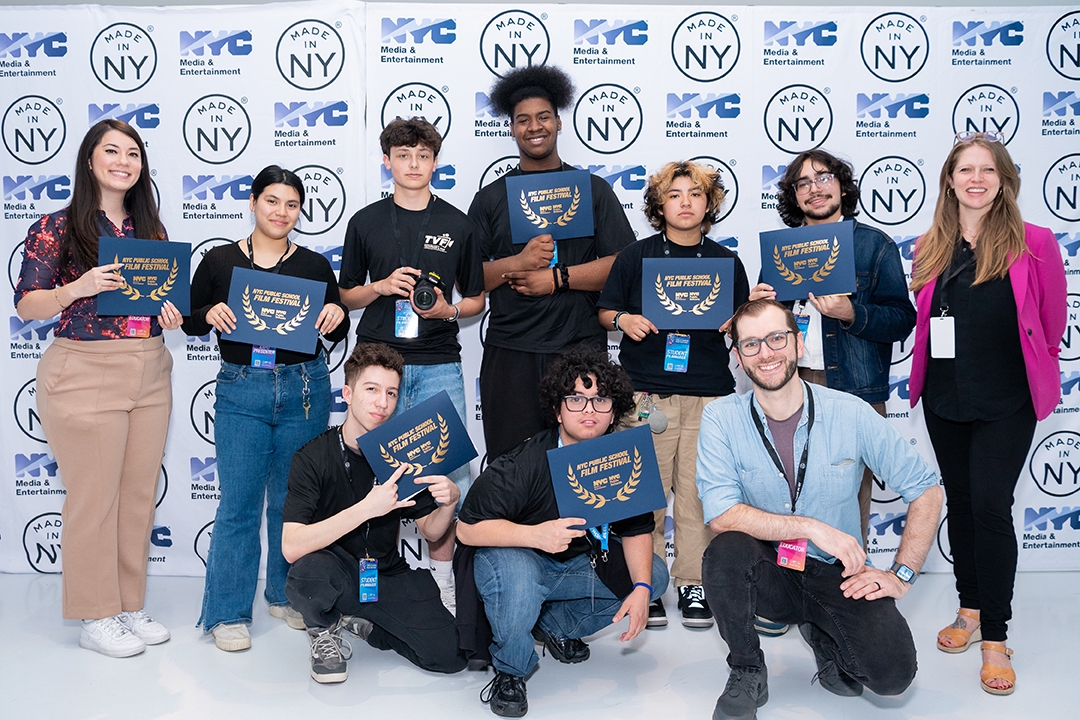 students from NYC public school film festival standing behind step and repeat