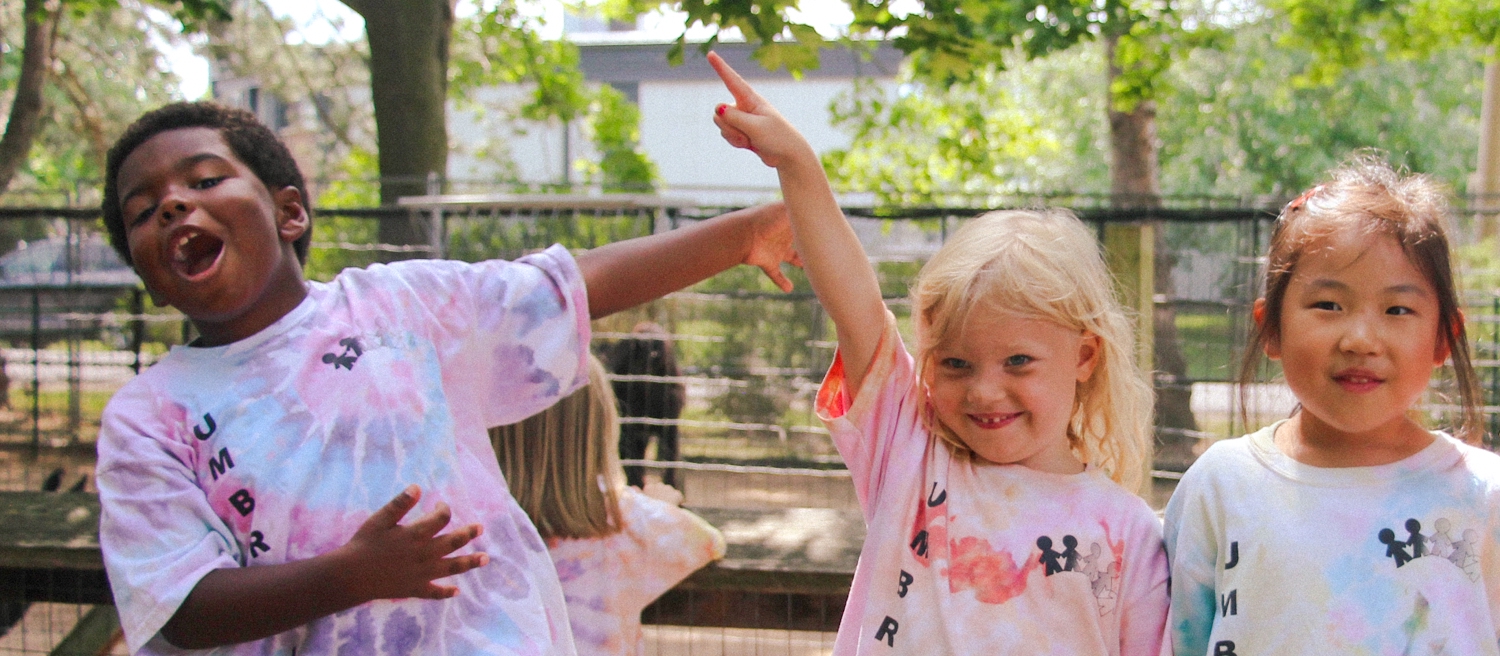 educator with two kinders outside