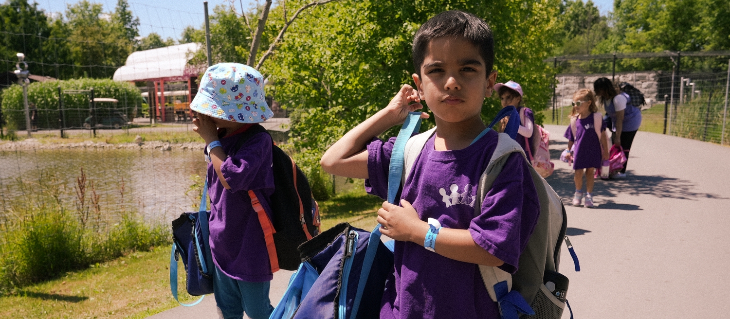 educator with two kinders outside