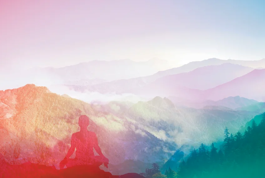 Illustration of the profile of a person sitting cross-legged overlooking a mist-filled valley.