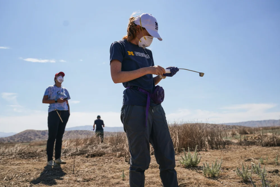 Three workers in a field in Santa Margarita, Calif., collect soil samples