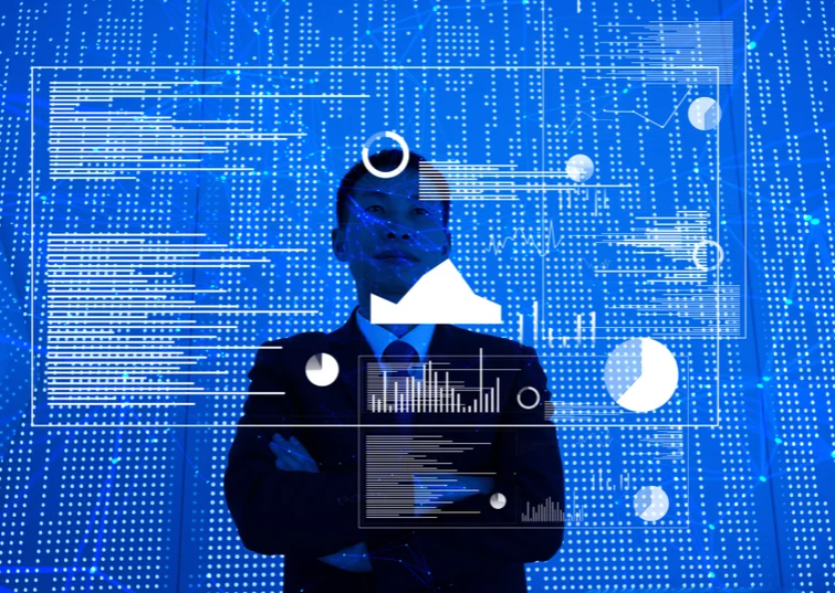 Futuristic graphs and illustrations displayed in air in front of a man in a suit.