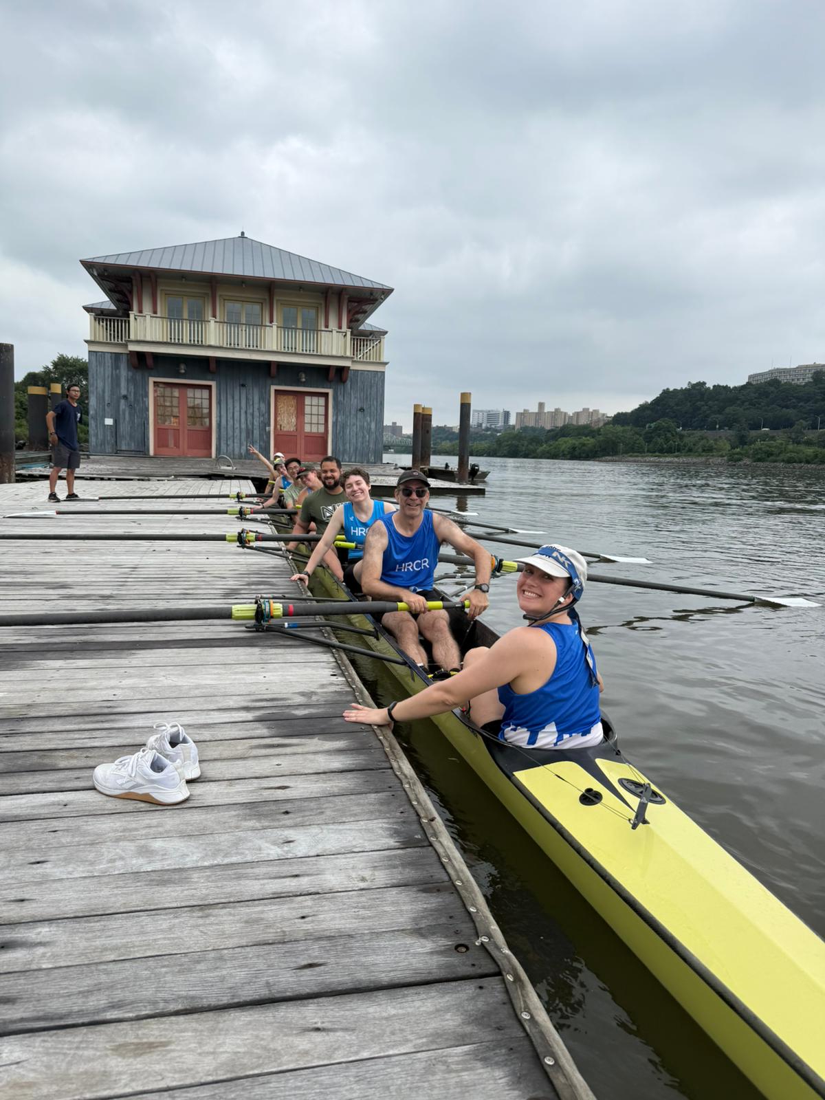Image of an eight person shell with HRCR rowers on the dock at Peter Jay Sharp Boathouse
