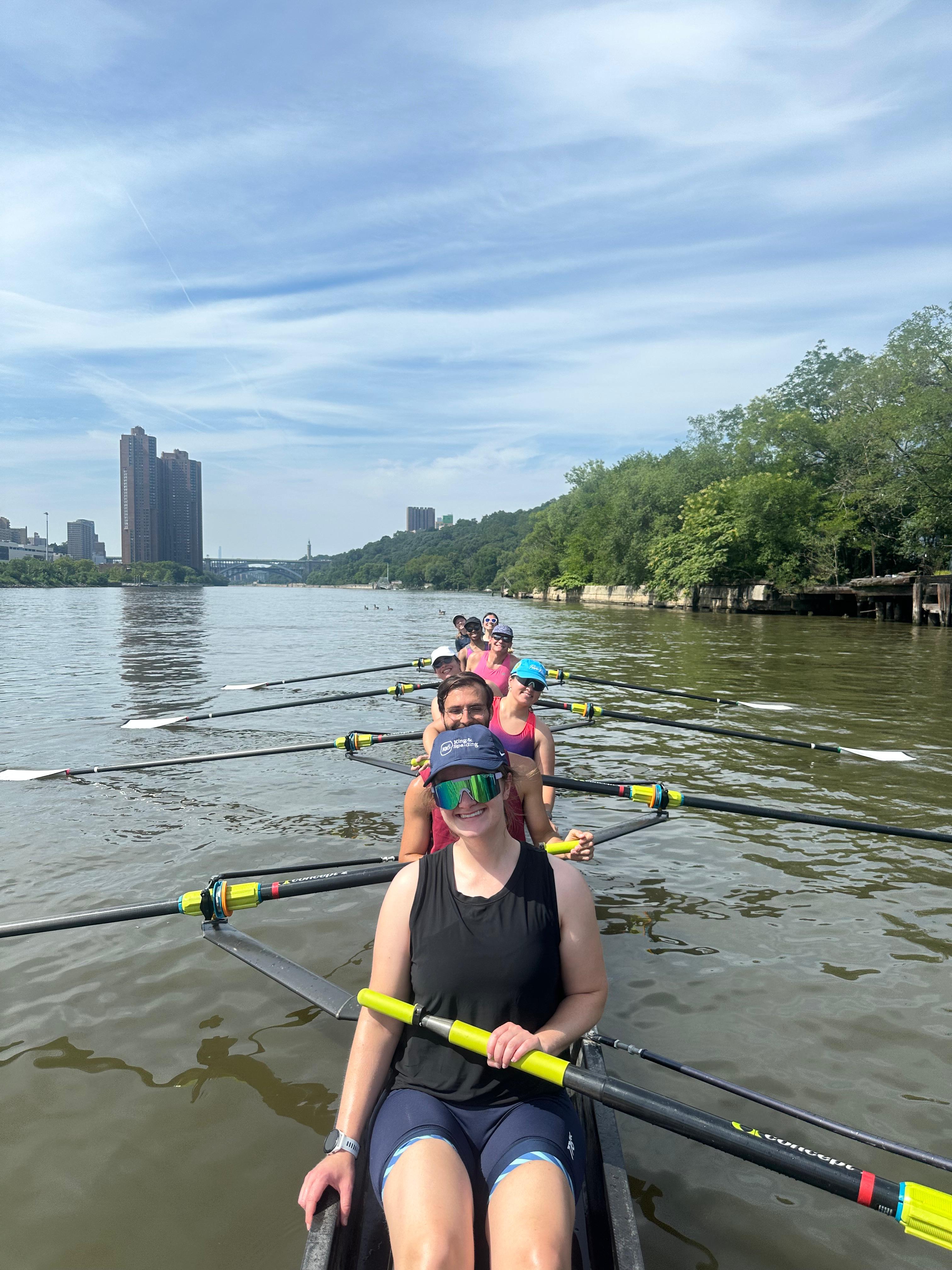 An eight-person shell on the Harlem River, pictured from the coxswain's seat.