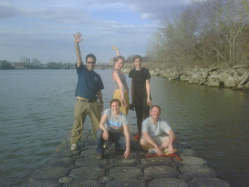 Five people pose on a bubble dock on the Harlem River.