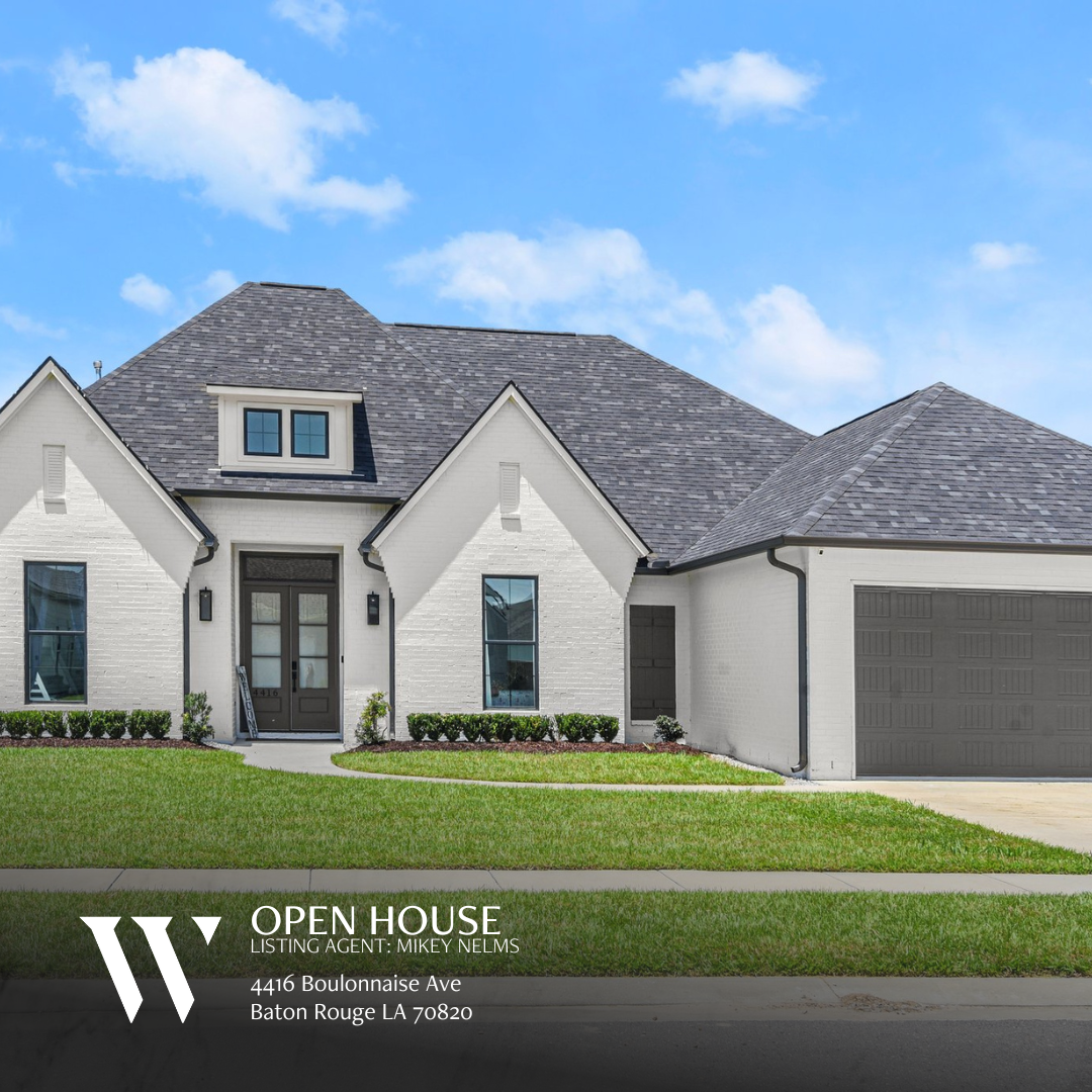 Front view of a contemporary single-story home at 4416 Boulonnais Ave, Baton Rouge, LA 70820. The property showcases a clean, minimalist design with a light-colored exterior and a two-car garage. A small front lawn with simple landscaping enhances the curb appeal, and the home features a modern roofline and large windows, allowing for plenty of natural light.