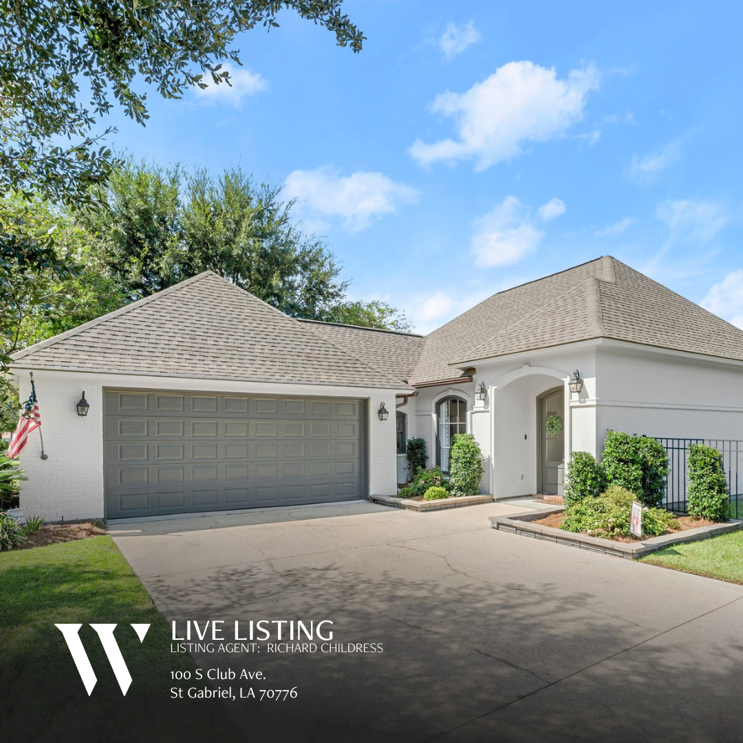 Exterior view of a single-story home at 100 S Club Ave, St Gabriel, LA 70776. The property features a well-maintained front lawn, a paved driveway leading to a two-vehicle garage.. The home has a light-colored facade, offering a welcoming and charming appearance.