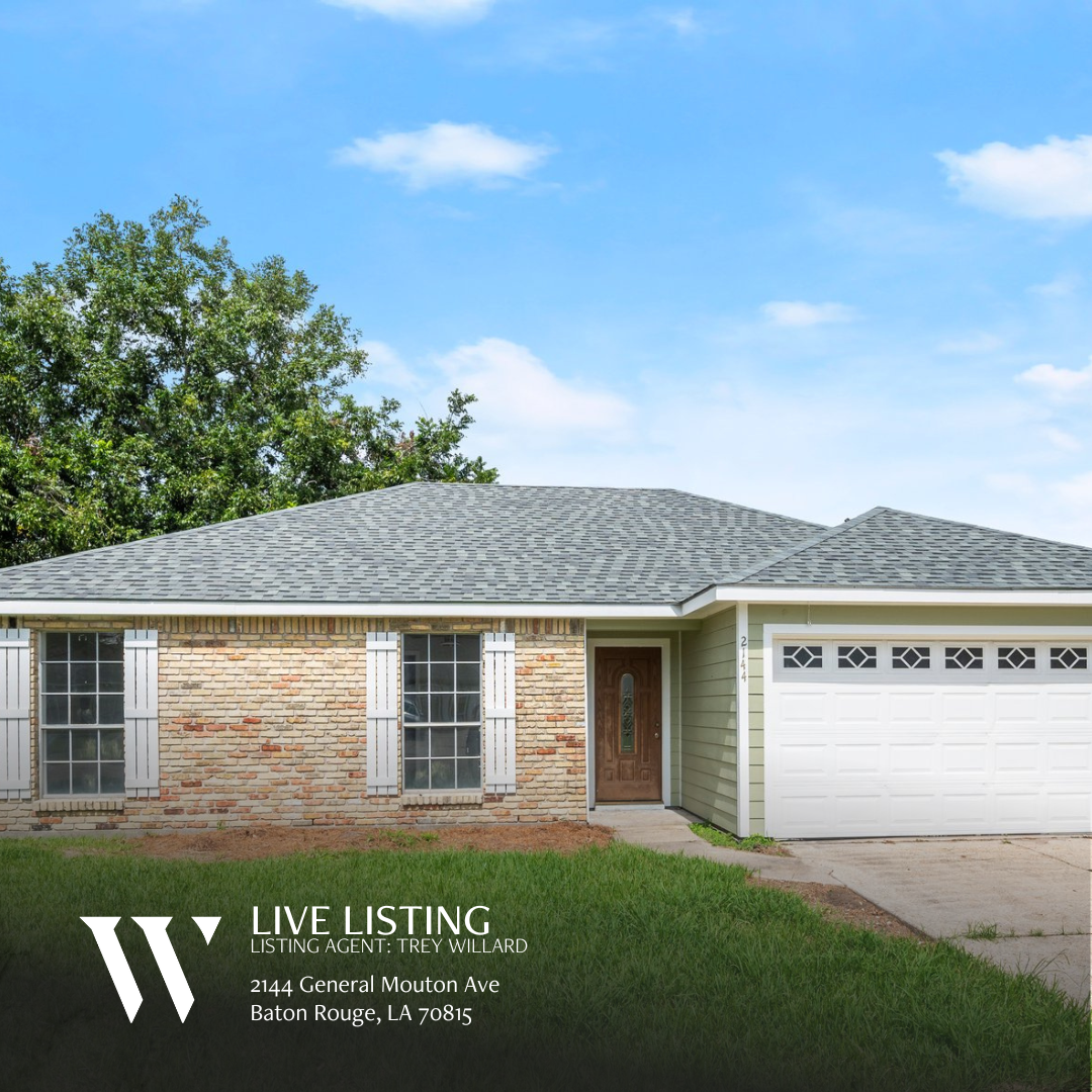 Front view of a spacious single-story home at 2144 General Mouton Ave, Baotn Rouge LA 70810. The property features a front lawn with mature trees and a paved driveway. The home has a light-colored brick facade, white trim, and a welcoming front door..