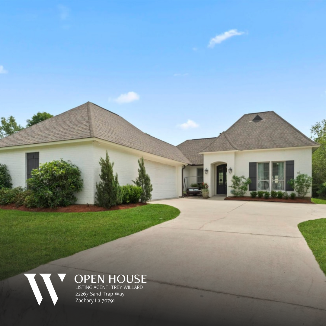 Exterior view of a modern two-story home located at 12821 Thoroughbred Ln, Walker, LA 70785. The property features a spacious front yard with well-maintained landscaping and a paved driveway leading to an attached two-car garage. The home has a light-colored facade with brick accents, large windows, and a welcoming front entrance.