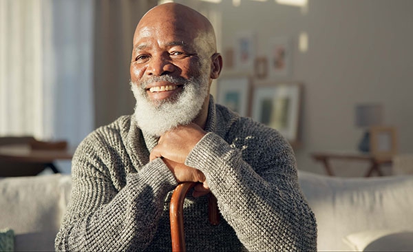 Man smiling with cane