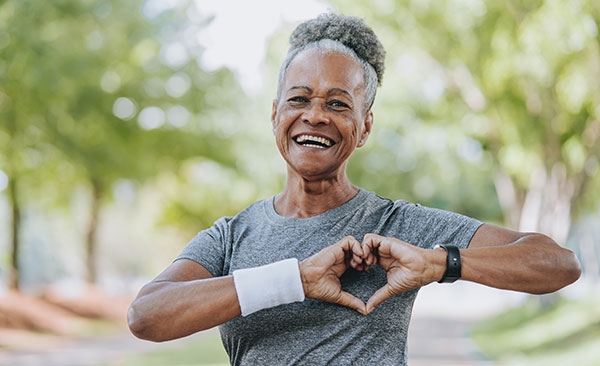 woman making heart symbol with hands