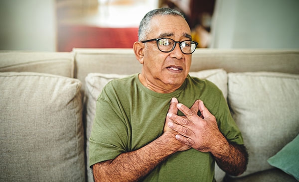 man holding his chest near his heart