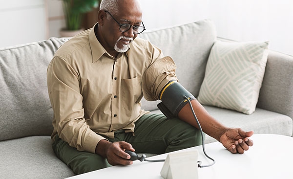 man taking his blood pressure at home