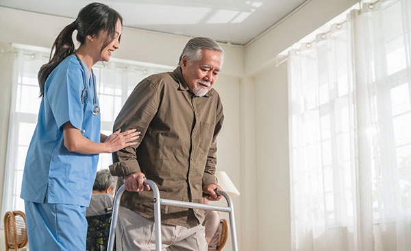 Nurse and older man in walker