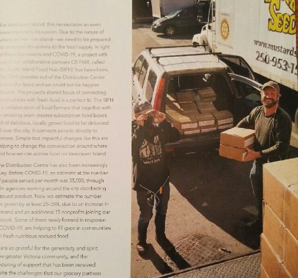 Ben and a volunteer move cases of food in support of the Red Cedar Cafe's community meal program