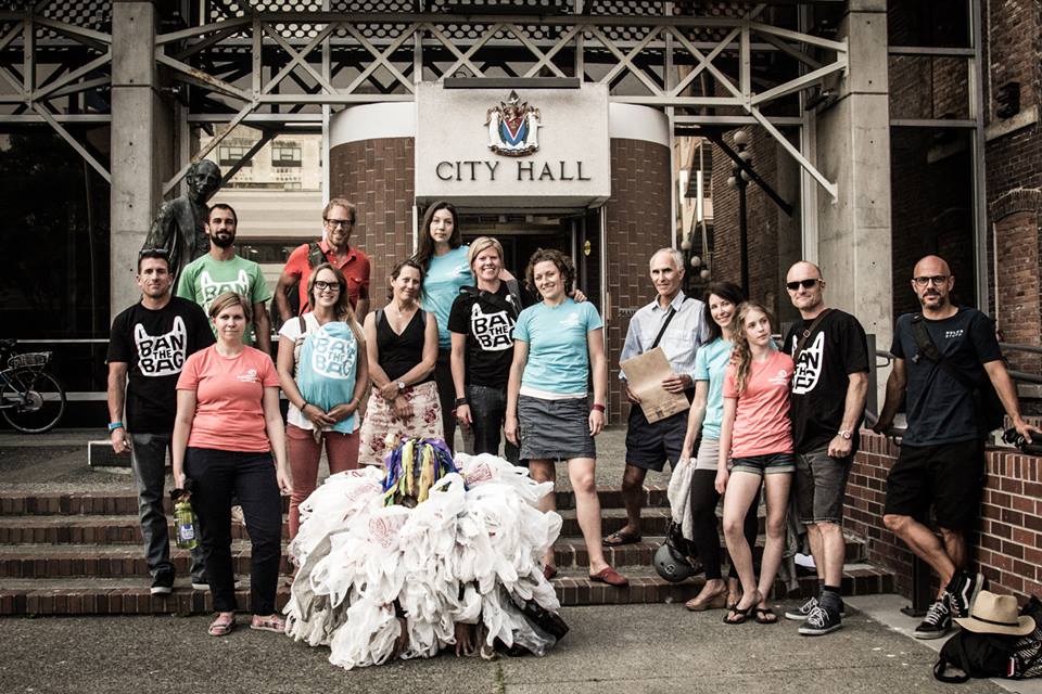 Activists with Surfrider Vancouver Island rally in front of Victoria City Hall, advocating for a ban on single-use checkout bags