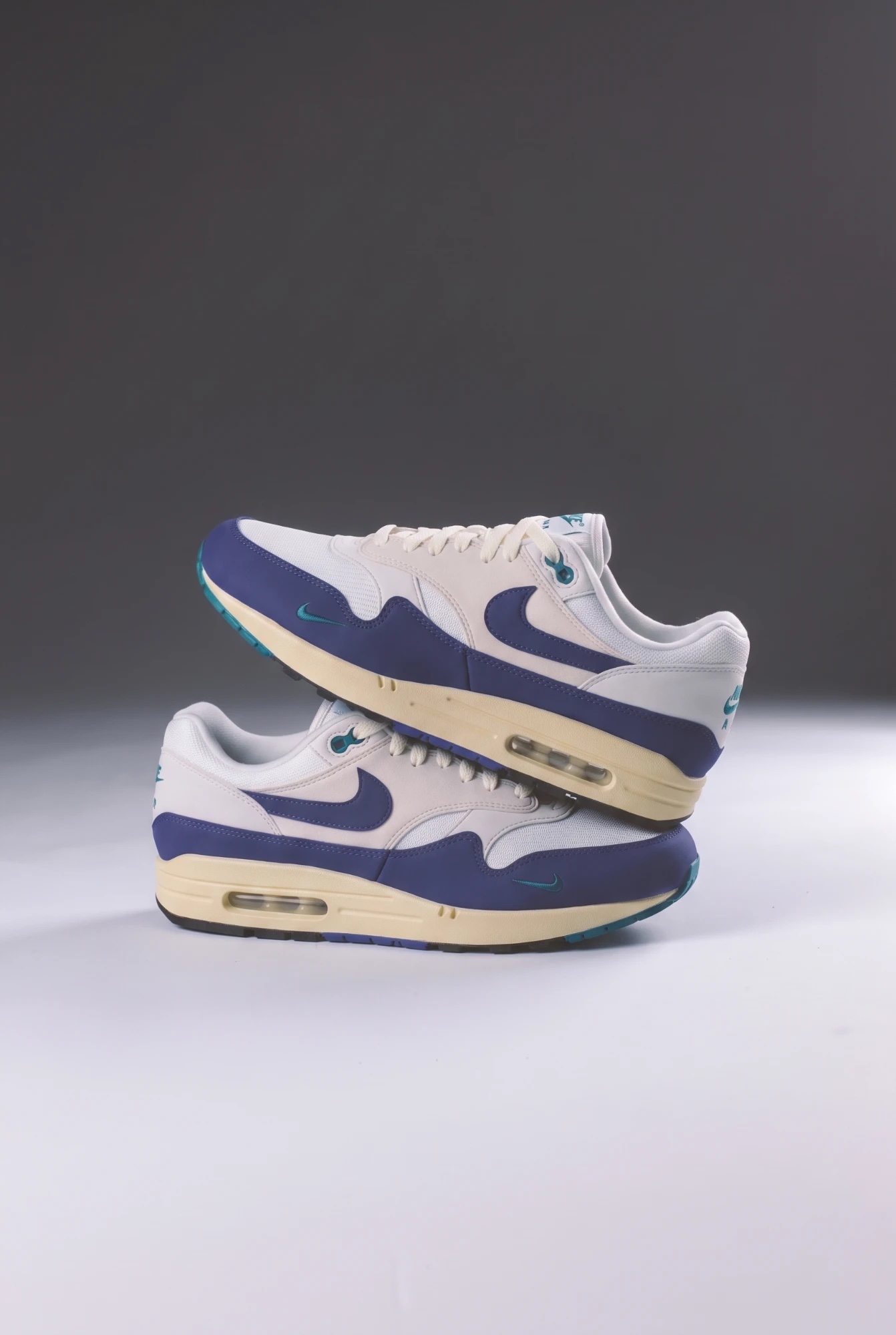 Two pairs of Nike Air Max 1 Athletic Department Deep Royal Blue stacked
