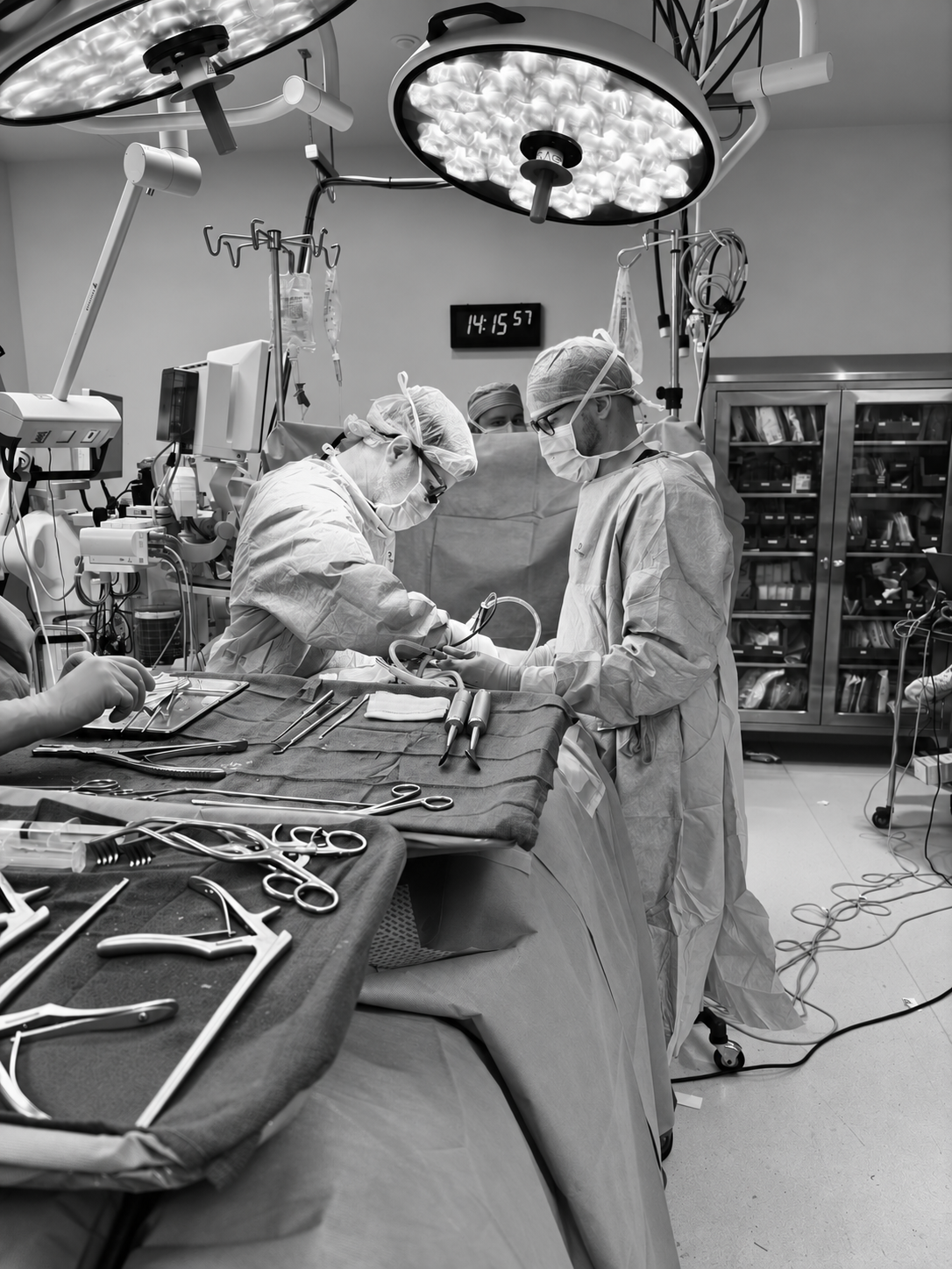 Black and white photograph of surgeons in an operating room, from the ONI flyer