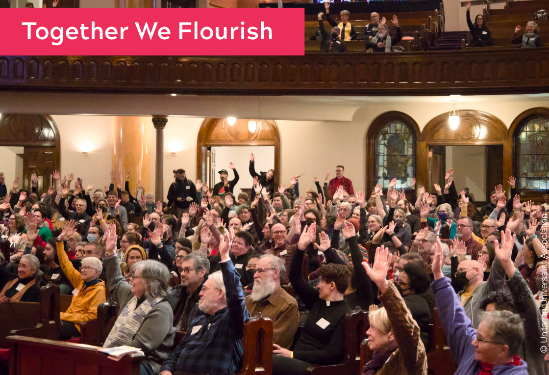 Congregation members seated in pews with hands raised. Together We Flourish.